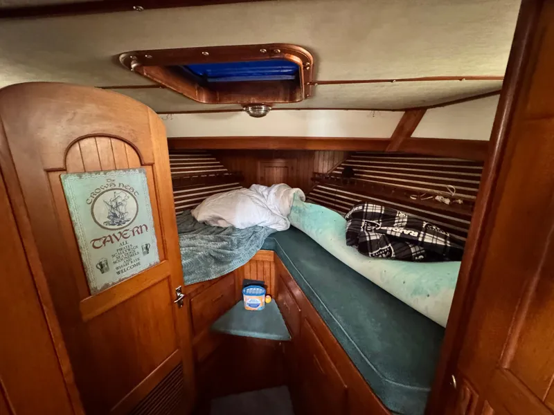 Slide: The Image of 1980 DeFever Trunk Cabin Motoryacht interior with cozy sleeping area and wooden accents. - 4