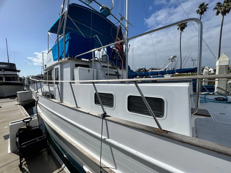 Slide: The Image of 1980 DeFever Trunk Cabin Motoryacht with Cummins repower docked under clear skies. - 7