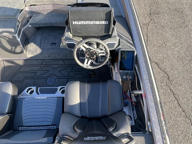 Slide: The Image of 2025 Skeeter FXR20 Limited boat cockpit with Humminbird electronics and sleek steering wheel design. - 13