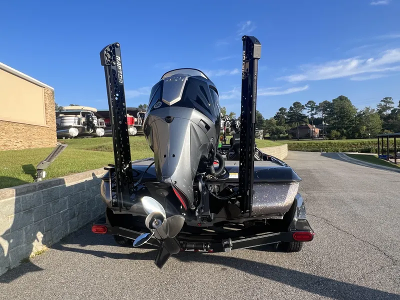 Slide: The Image of 2025 Skeeter FXR20 Limited boat with powerful outboard motor, parked outdoors. - 2