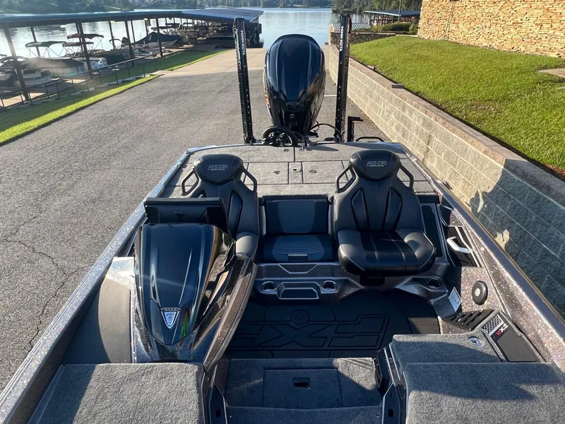 Slide: The Image of 2025 Skeeter FXR20 Limited boat with sleek design, dual seats, and lake view. - 3