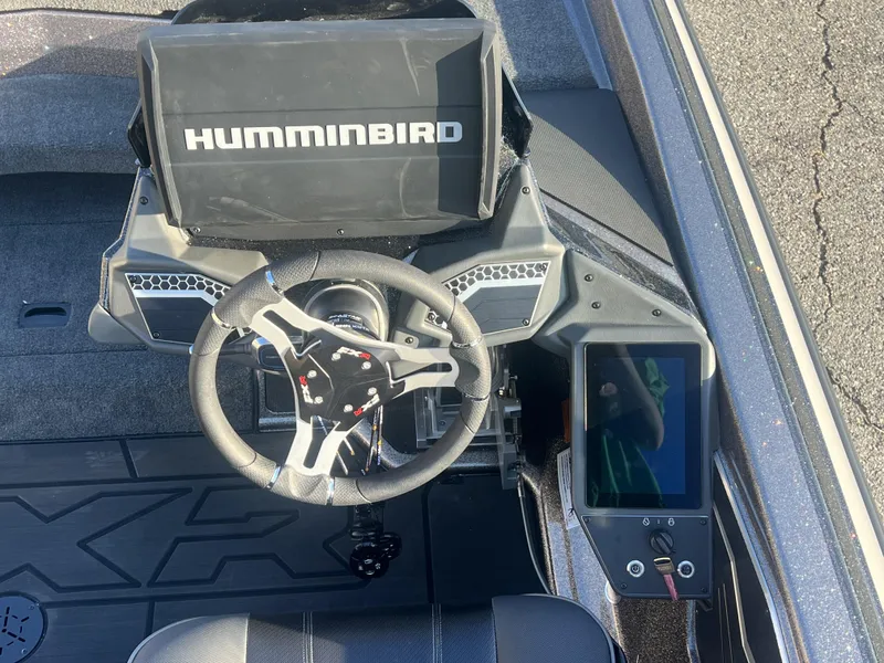 Slide: The Image of 2025 Skeeter FXR20 Limited boat dashboard with Humminbird display and steering wheel. - 5