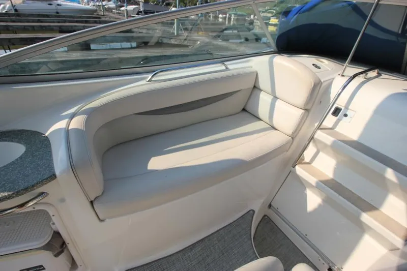 Slide: The Image of 2006 Chaparral 276 Signature Cruiser interior seating area with white upholstery. - 12