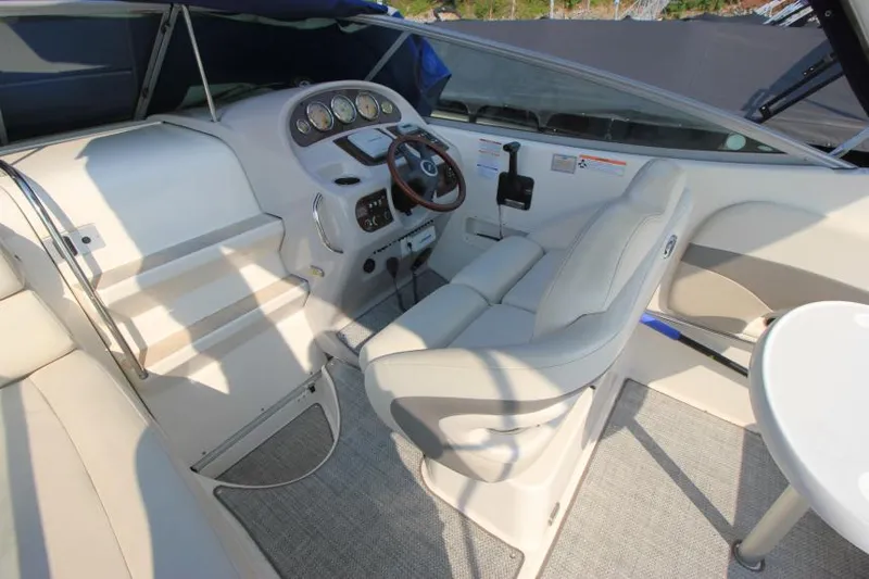 Slide: The Image of 2006 Chaparral 276 Signature Cruiser cockpit with steering wheel and control panel. - 13