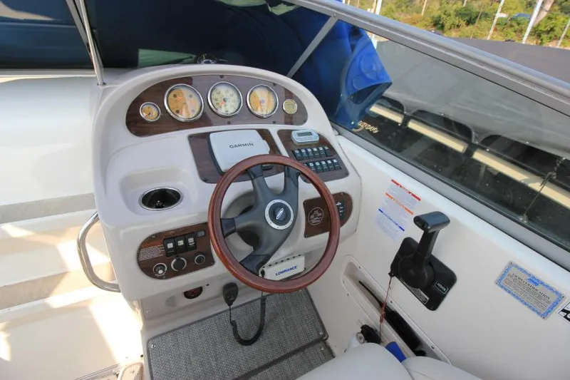 Slide: The Image of 2006 Chaparral 276 Signature Cruiser dashboard with steering wheel and control panel. - 15
