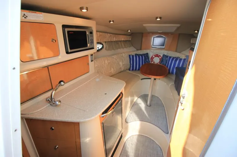 Slide: The Image of Interior of 2006 Chaparral 276 Signature Cruiser with kitchenette and cozy seating area. - 19