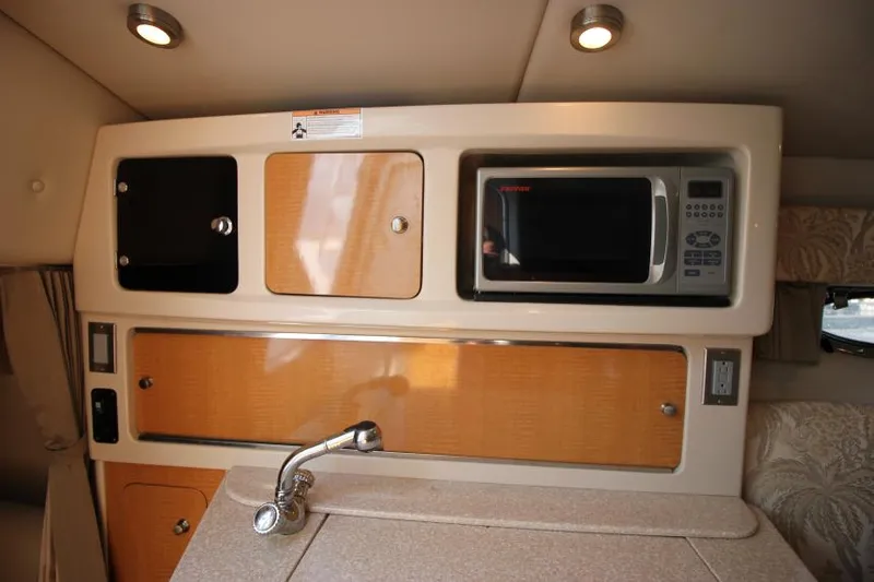 Slide: The Image of Interior of 2006 Chaparral 276 Signature Cruiser with microwave and storage cabinets. - 27