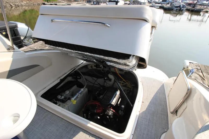 Slide: The Image of 2006 Chaparral 276 Signature Cruiser engine compartment open at marina. - 35