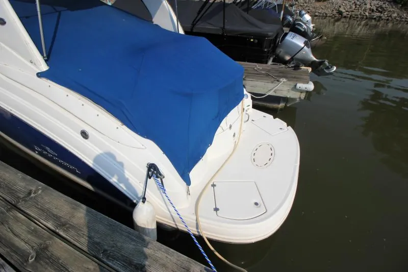 Slide: The Image of 2006 Chaparral 276 Signature Cruiser docked with blue cover. - 6