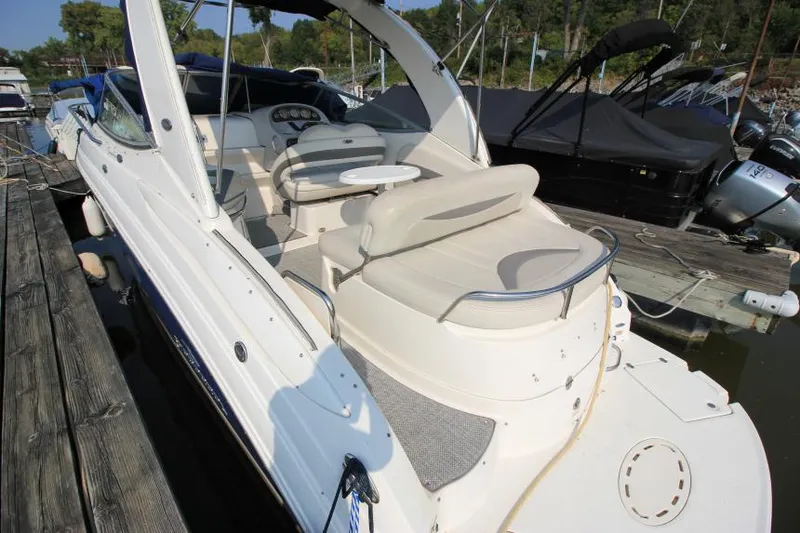 Slide: The Image of 2006 Chaparral 276 Signature Cruiser docked, featuring spacious seating and sleek design. - 7