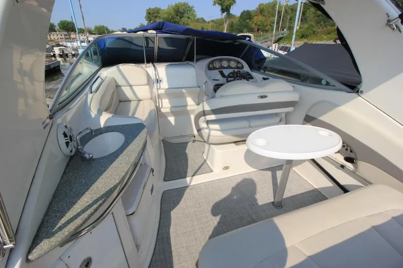 Slide: The Image of 2006 Chaparral 276 Signature Cruiser interior with seating, table, and helm. - 10