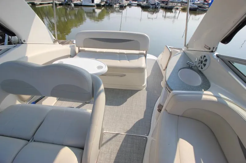 Slide: The Image of 2006 Chaparral 276 Signature Cruiser interior with seating and table, docked at marina. - 17