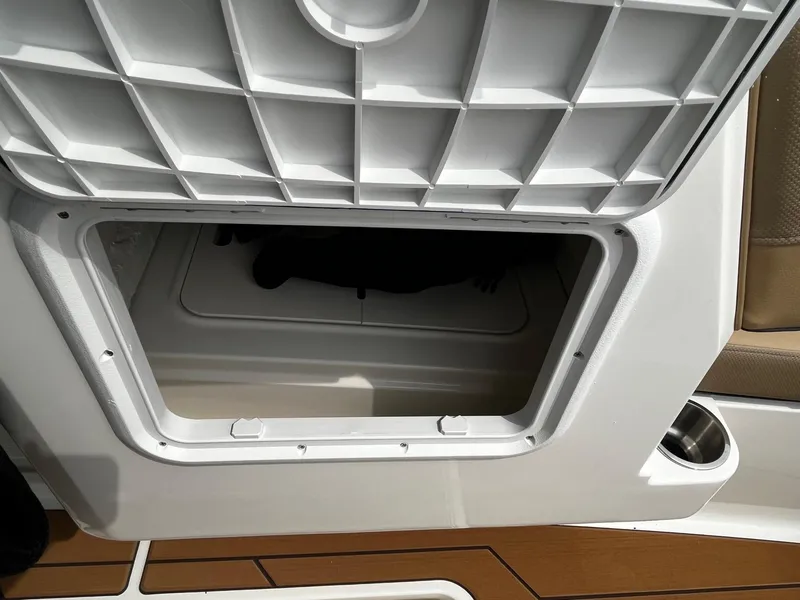 Slide: The Image of Open storage compartment on 2024 Bayliner DX2000 boat. - 14