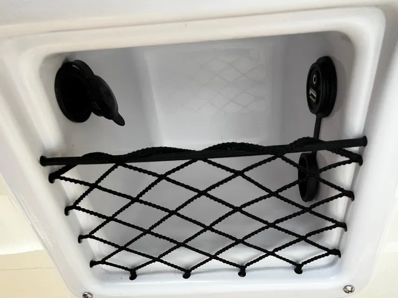 Slide: The Image of Storage compartment with netting in 2024 Bayliner DX2000 boat. - 15