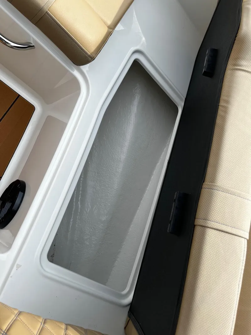 Slide: The Image of Storage compartment in 2024 Bayliner DX2000 boat with beige seating. - 16