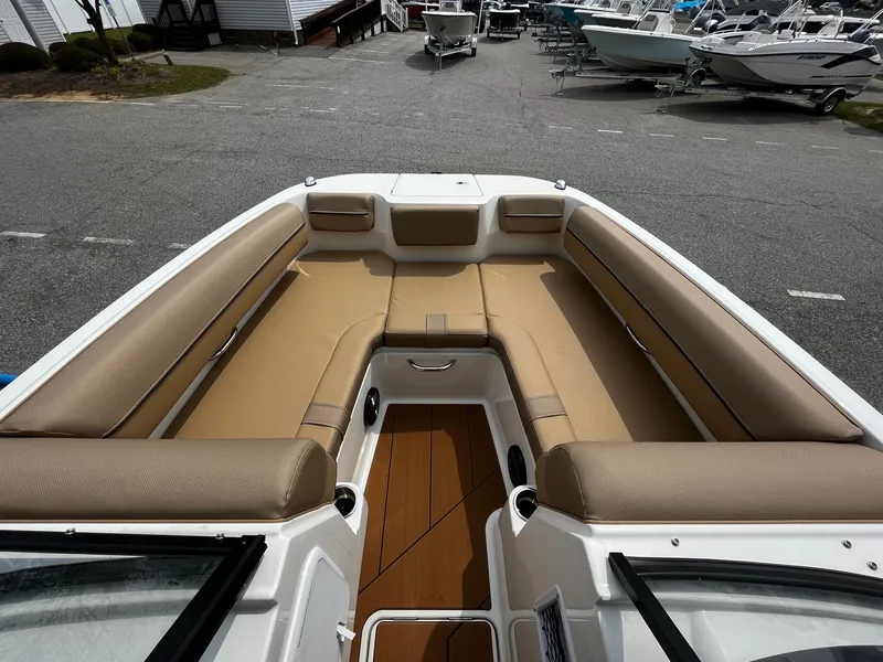 Slide: The Image of 2024 Bayliner DX2000 boat with spacious tan seating and modern design. - 19