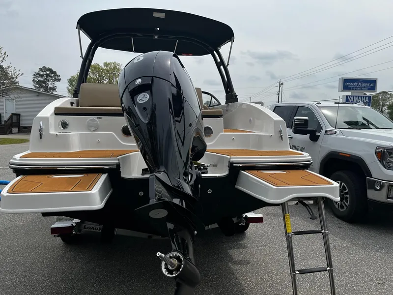 Slide: The Image of 2024 Bayliner DX2000 boat with outboard motor and swim platforms. - 2
