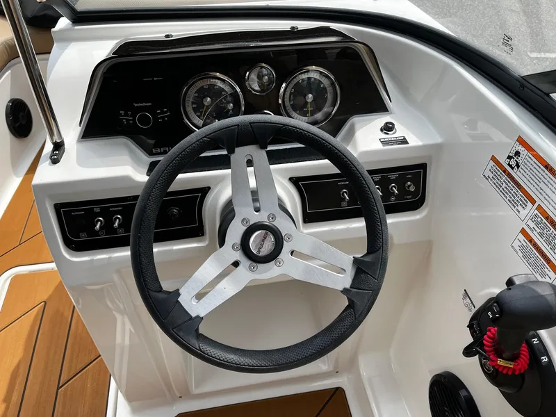 Slide: The Image of 2024 Bayliner DX2000 boat dashboard with steering wheel and instrument panel. - 20