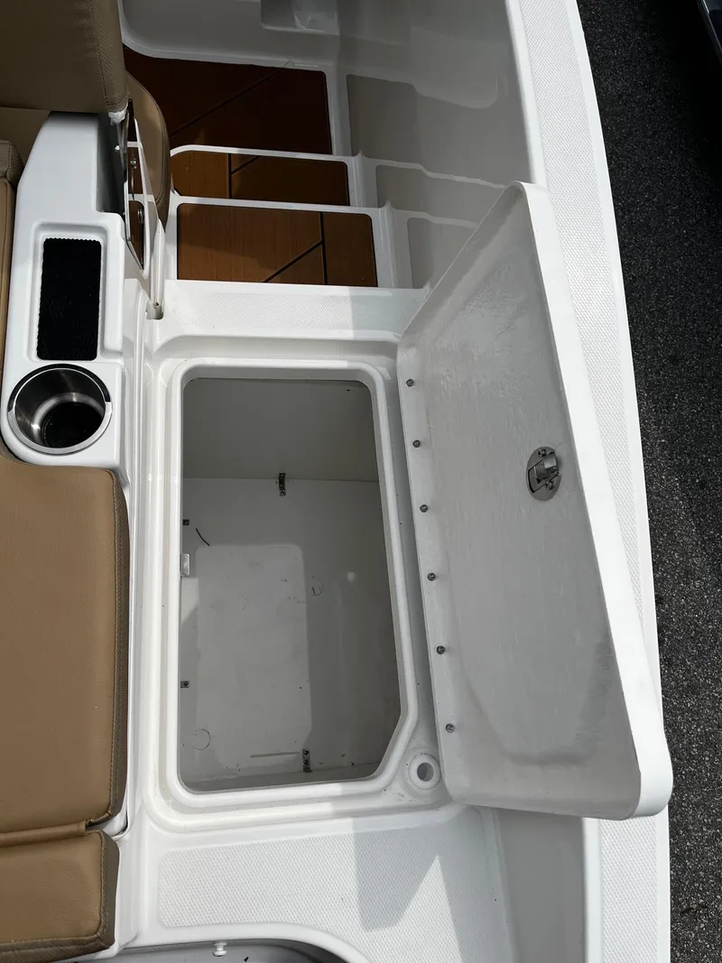 Slide: The Image of 2024 Bayliner DX2000 boat storage compartment and seating area. - 5