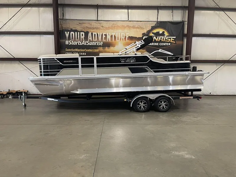 Slide: The Image of 2023 SunCatcher Elite 324SS pontoon boat on trailer in indoor showroom. - 0