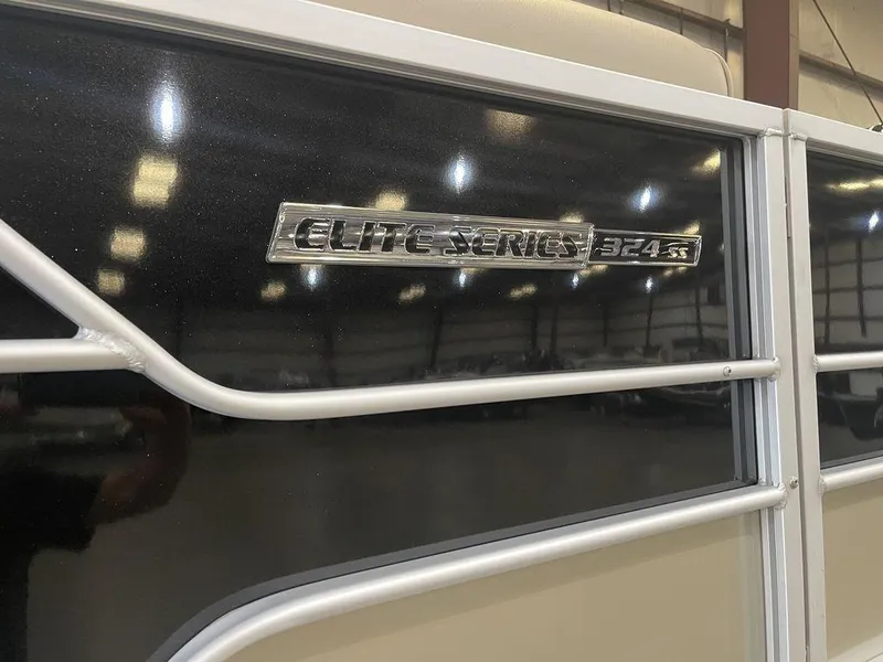 Slide: The Image of 2023 SunCatcher Elite 324SS boat emblem in a showroom. - 10