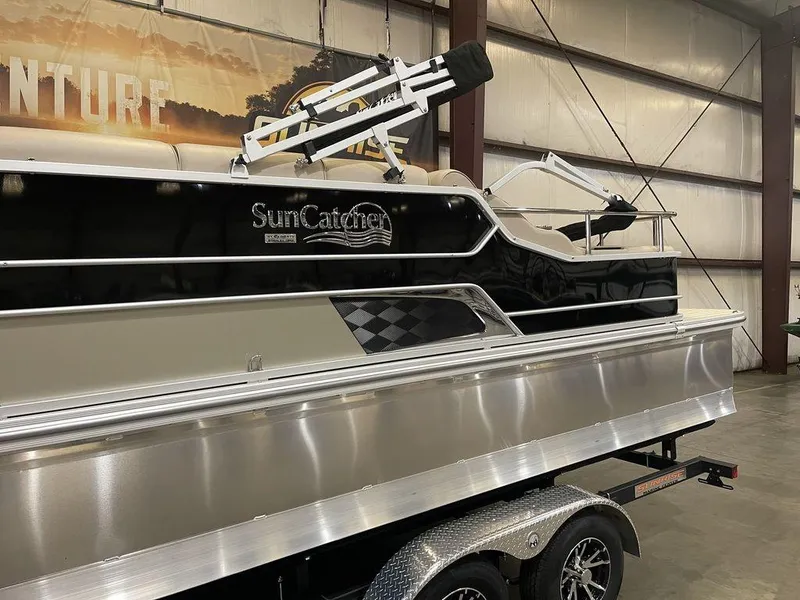Slide: The Image of 2023 SunCatcher Elite 324SS pontoon boat in showroom. - 11