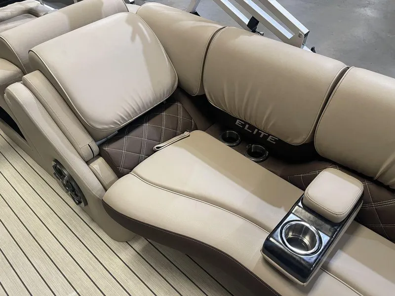Slide: The Image of SunCatcher Elite 324SS 2023 boat interior with beige and brown leather seating. - 2