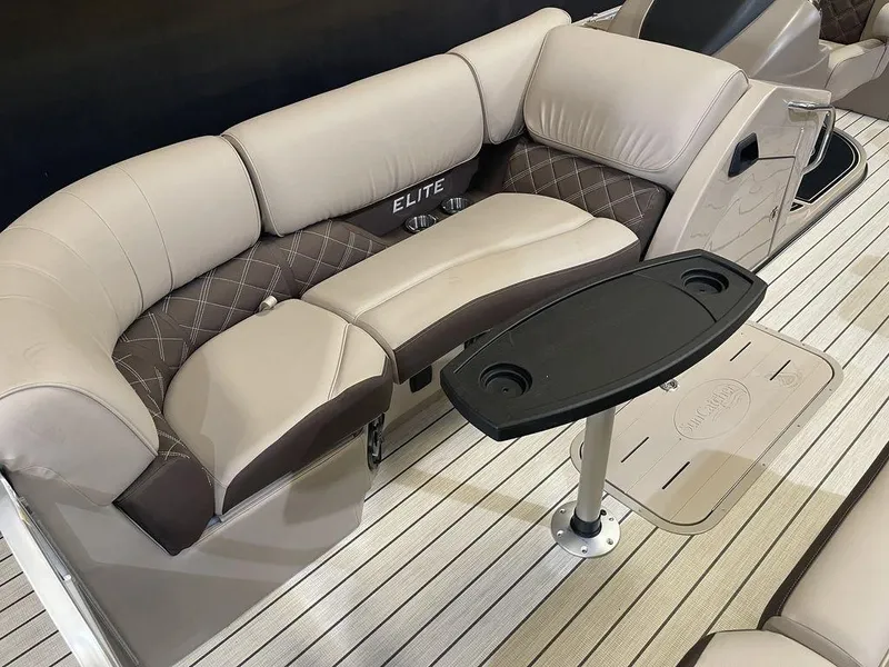 Slide: The Image of 2023 SunCatcher Elite 324SS boat interior with plush seating and table. - 3