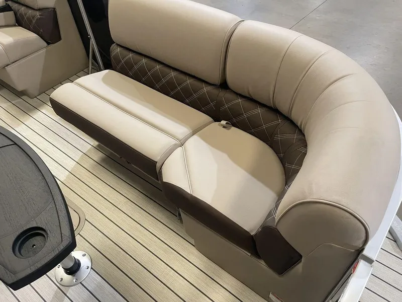 Slide: The Image of 2023 SunCatcher Elite 324SS boat interior with beige and brown cushioned seating. - 5