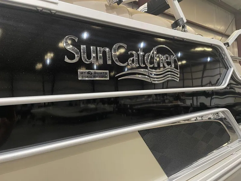 Slide: The Image of 2023 SunCatcher Elite 324SS boat in a showroom. - 8
