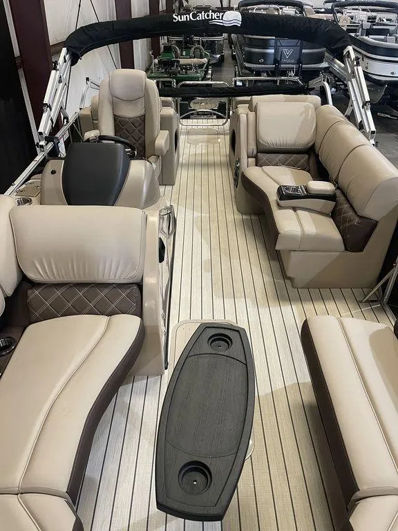 Slide: The Image of 2023 SunCatcher Elite 324SS pontoon boat with luxurious seating and modern design. - 9