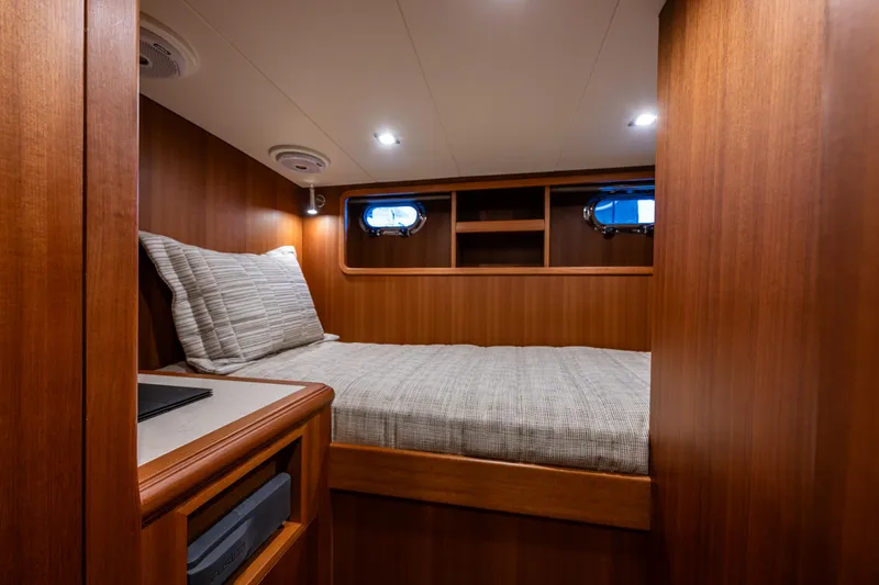 Slide: The Image of 2025 Hampton Endurance 630 Euro yacht cabin with wooden interior and cozy bed. - 15