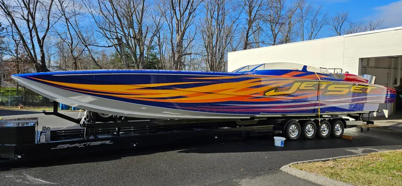 The Image of 2020 Skater 50 powerboat with vibrant graphics on a trailer. - 0
