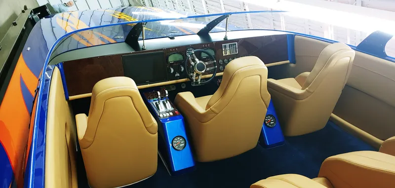Slide: The Image of Interior of a 2020 Skater 50 speedboat with tan leather seats and modern dashboard. - 10