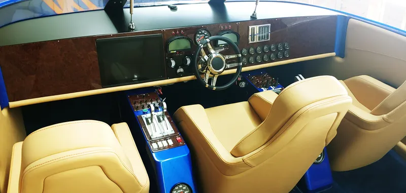 Slide: The Image of 2020 Skater 50 boat interior with tan leather seats and modern dashboard. - 19