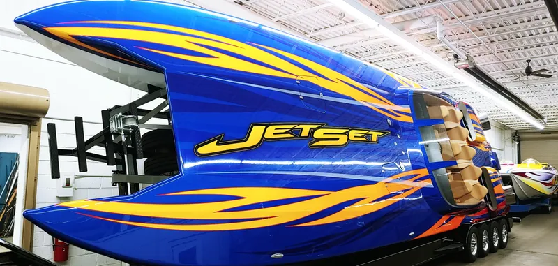 Slide: The Image of Blue Skater 50 boat with Jet Set graphics in a warehouse, model year 2020. - 2