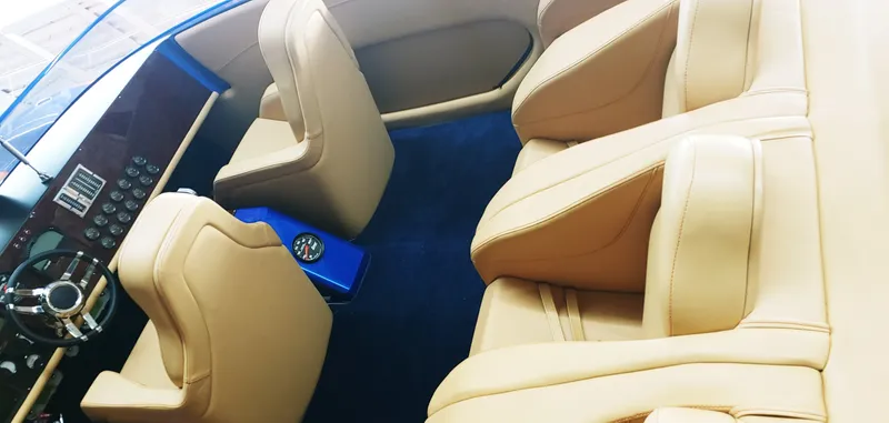 Slide: The Image of Luxurious interior of a 2020 Skater 50 boat with tan leather seats and blue accents. - 29