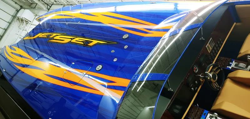 Slide: The Image of Skater 50 boat, 2020 model, blue with orange flames, Jet Set logo, cockpit view. - 30