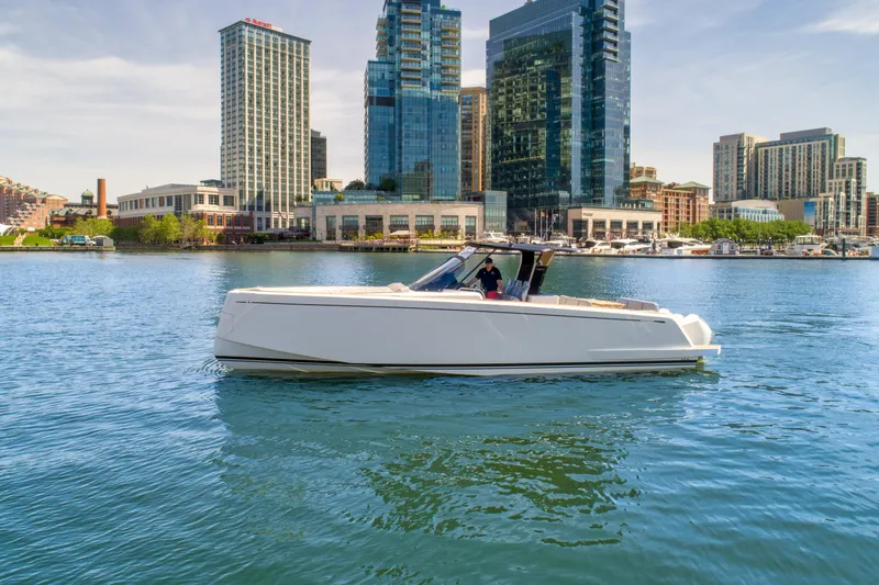 Slide: The Image of 2023 Pardo Yachts 38 cruising in urban waterfront with skyscrapers in the background. - 0