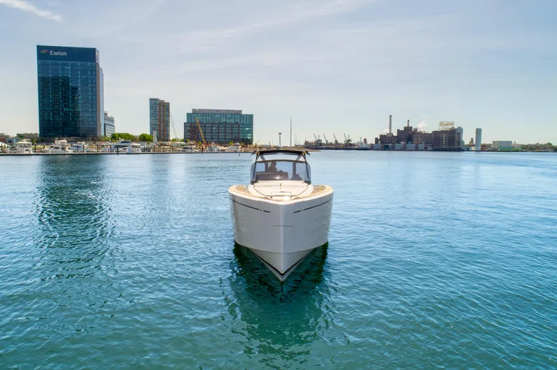 Slide: The Image of Pardo Yachts 38 (2023) on calm water with city skyline in the background. - 1