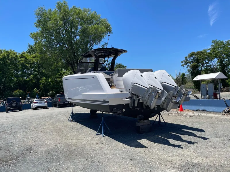 Slide: The Image of 2023 Pardo Yachts 38 on dry dock with triple outboard engines. - 11