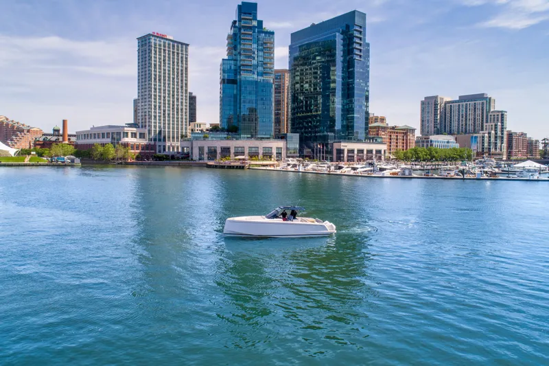 Slide: The Image of 2023 Pardo Yachts 38 cruising in urban waterfront with skyscrapers in the background. - 16
