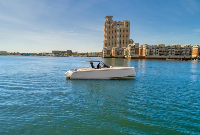 Slide: The Image of 2023 Pardo Yachts 38 cruising in a serene urban waterfront. - 3