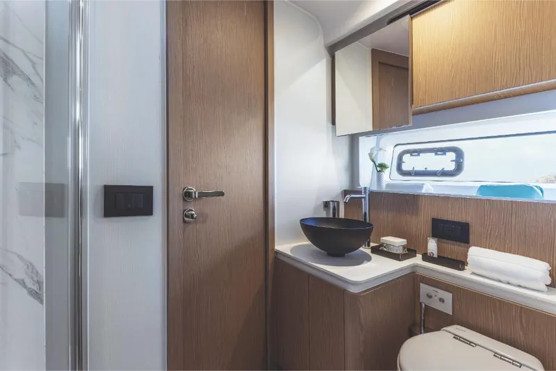 Slide: The Image of Modern bathroom interior of 2023 Azimut 53 yacht with wooden cabinetry. - 24