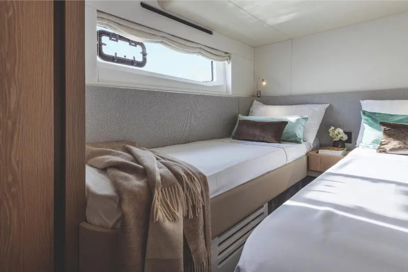 Slide: The Image of Luxurious twin bedroom in 2023 Azimut 53 yacht with modern decor. - 25