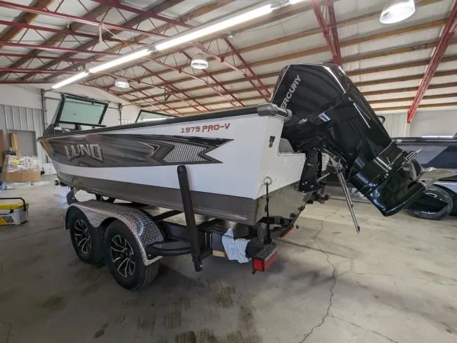 Slide: The Image of 2025 Lund 1975 Pro V Sport boat on trailer in indoor storage facility. - 11