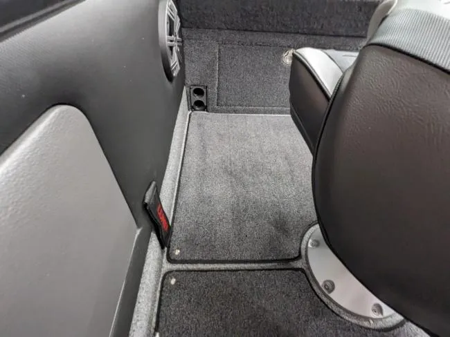 Slide: The Image of Interior of 2025 Lund 1975 Pro V Sport boat with carpeted flooring and seating. - 12