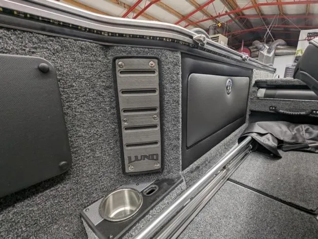 Slide: The Image of Interior of 2025 Lund 1975 Pro V Sport boat with cup holder and storage compartments. - 15
