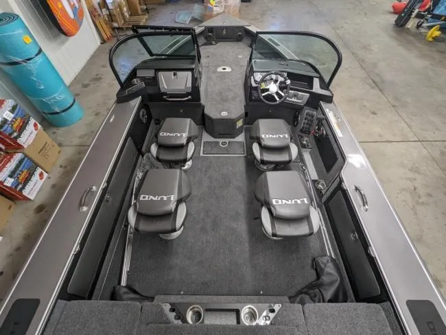 Slide: The Image of 2025 Lund 1975 Pro V Sport boat interior with four seats and steering console. - 3