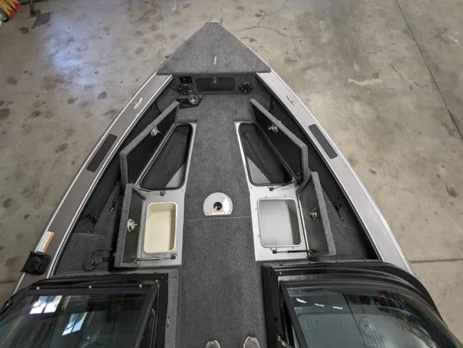 Slide: The Image of Interior view of 2025 Lund 1975 Pro V Sport fishing boat with open storage compartments. - 6